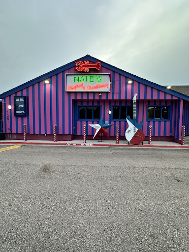 Nate's striped storefront lit up at night
