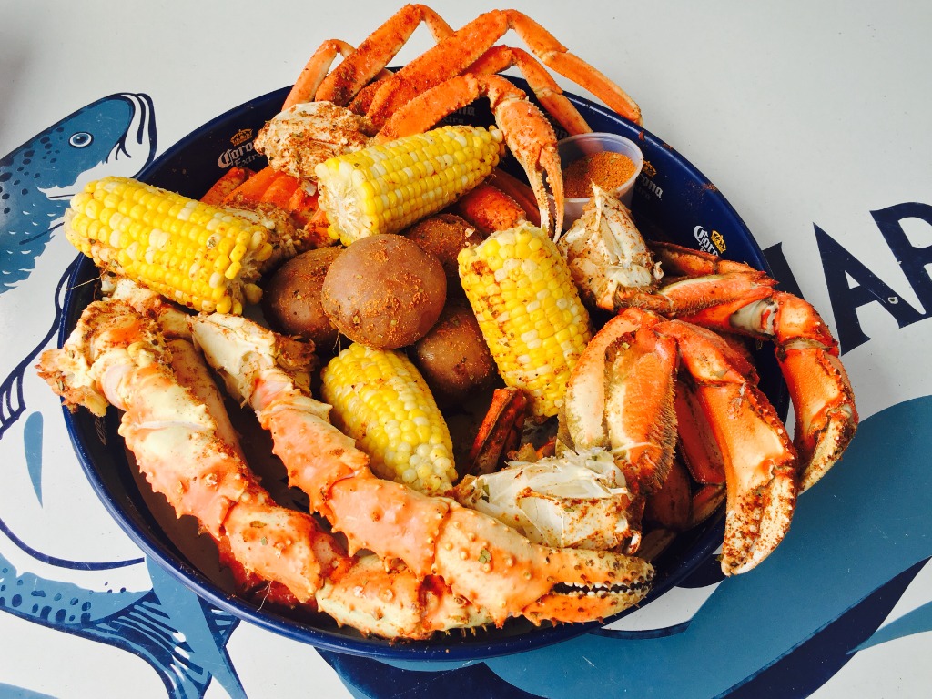 Loaded crab legs platter with sweet corn and potatoes